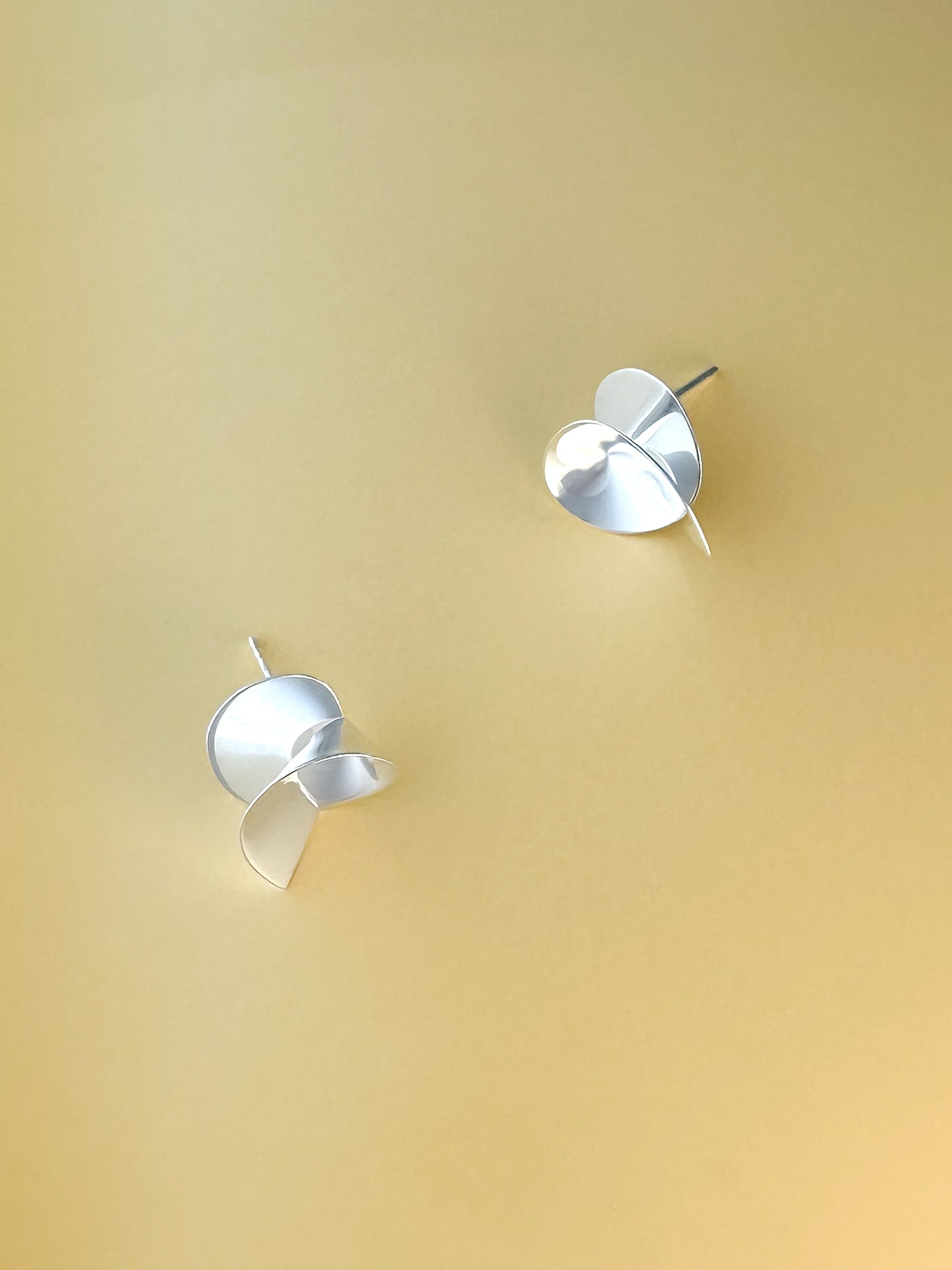 Coil II sculptural handmade earrings in silver by Sara Robertsson Jewellery