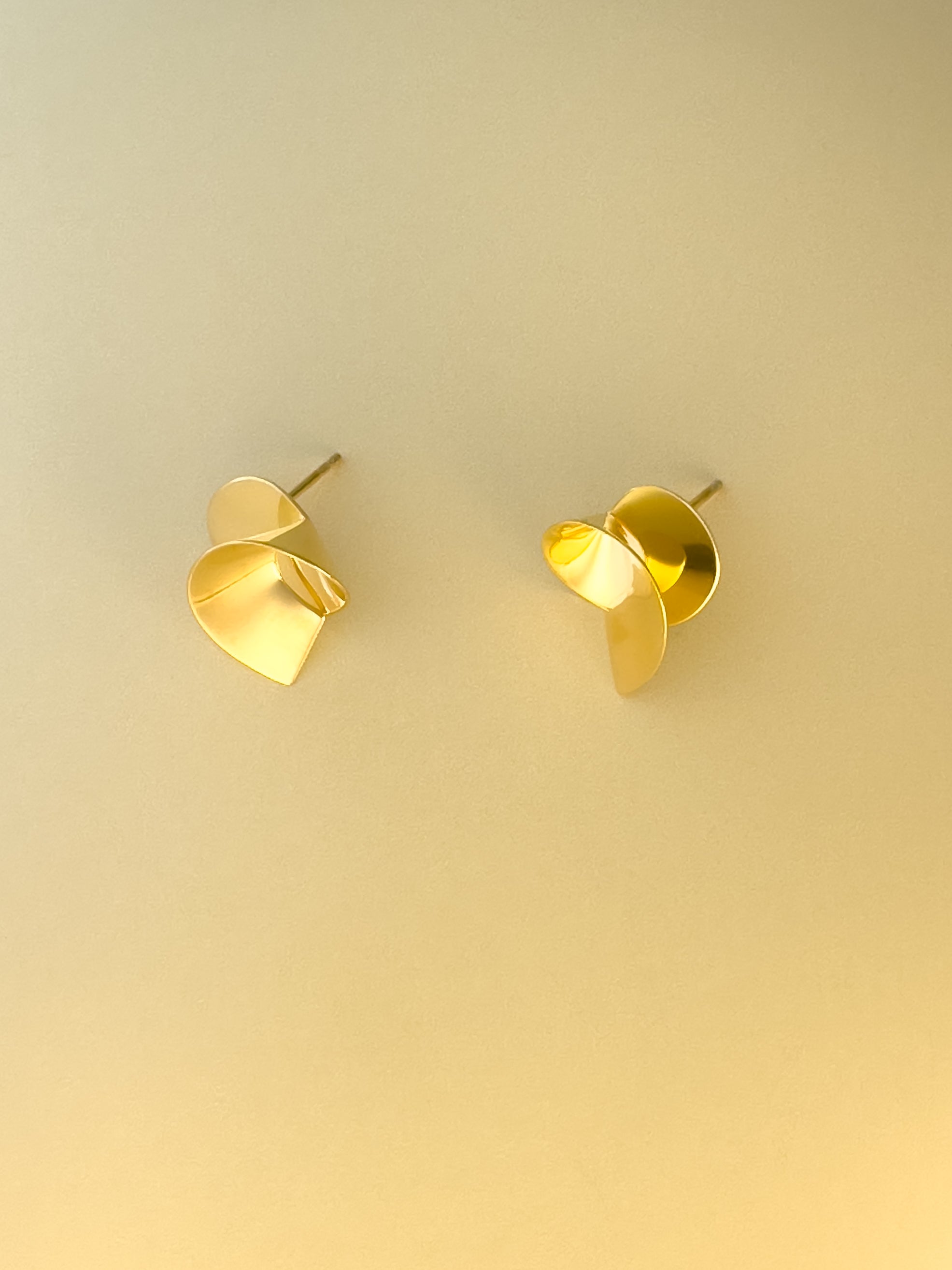 Coil II sculptural handmade earrings in gold vermeil by Sara Robertsson Jewellery