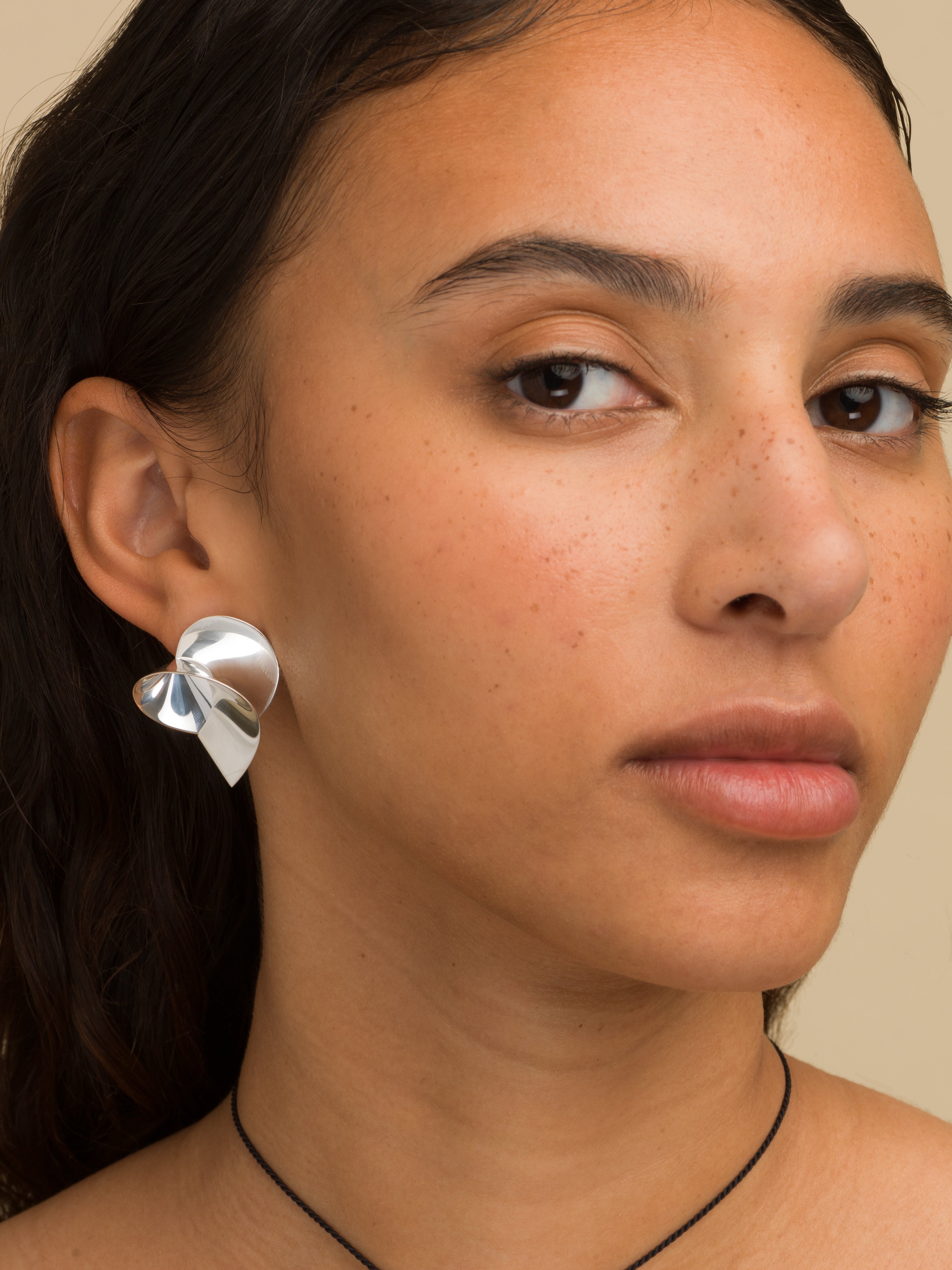 Coil sculptural earrings in silver by Sara Robertsson Jewellery