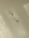 Pebble Stud Earrings in recycled sterling silver photographed in natural light.