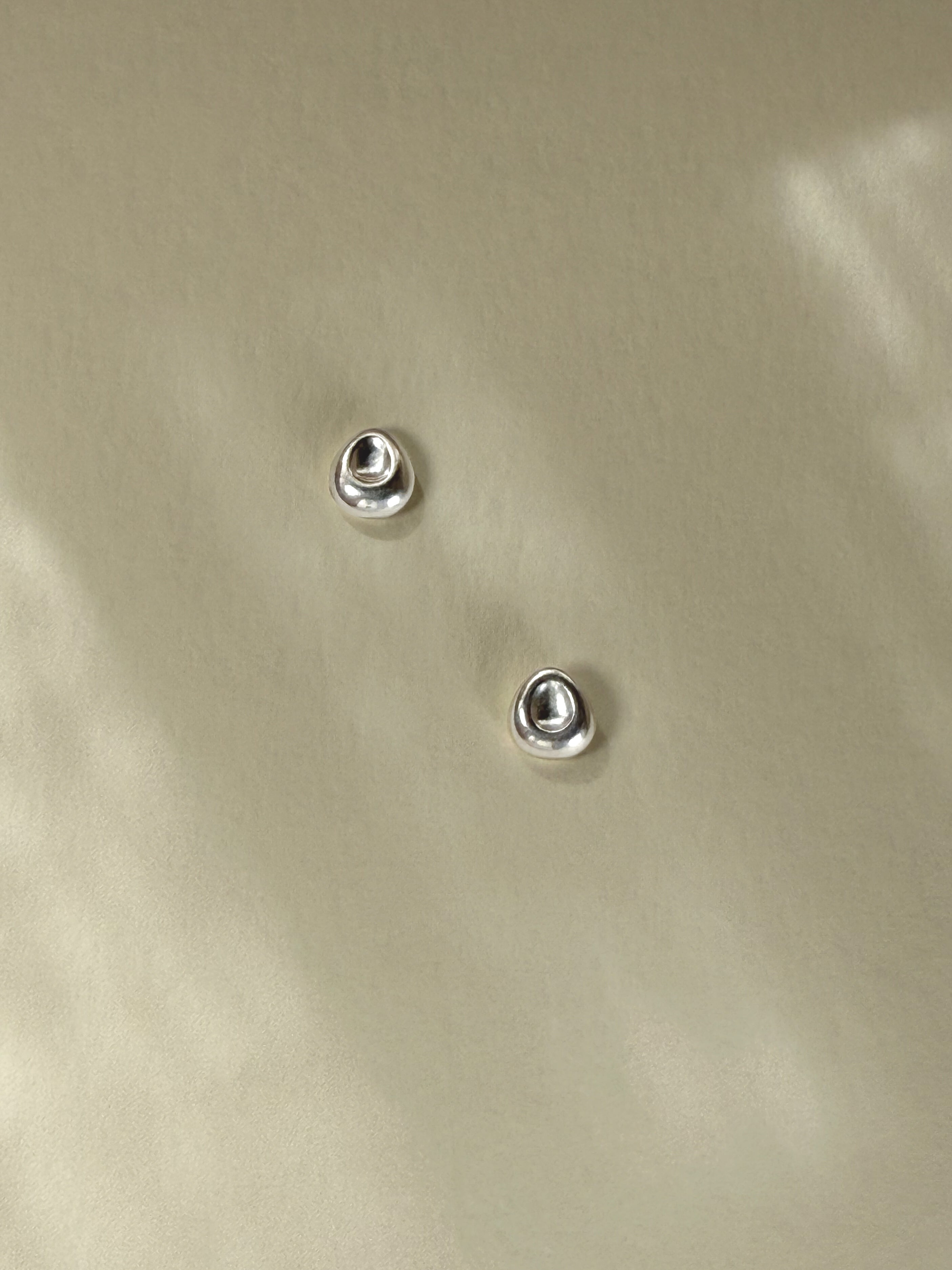 Pebble Stud Earrings in recycled sterling silver photographed in natural light.